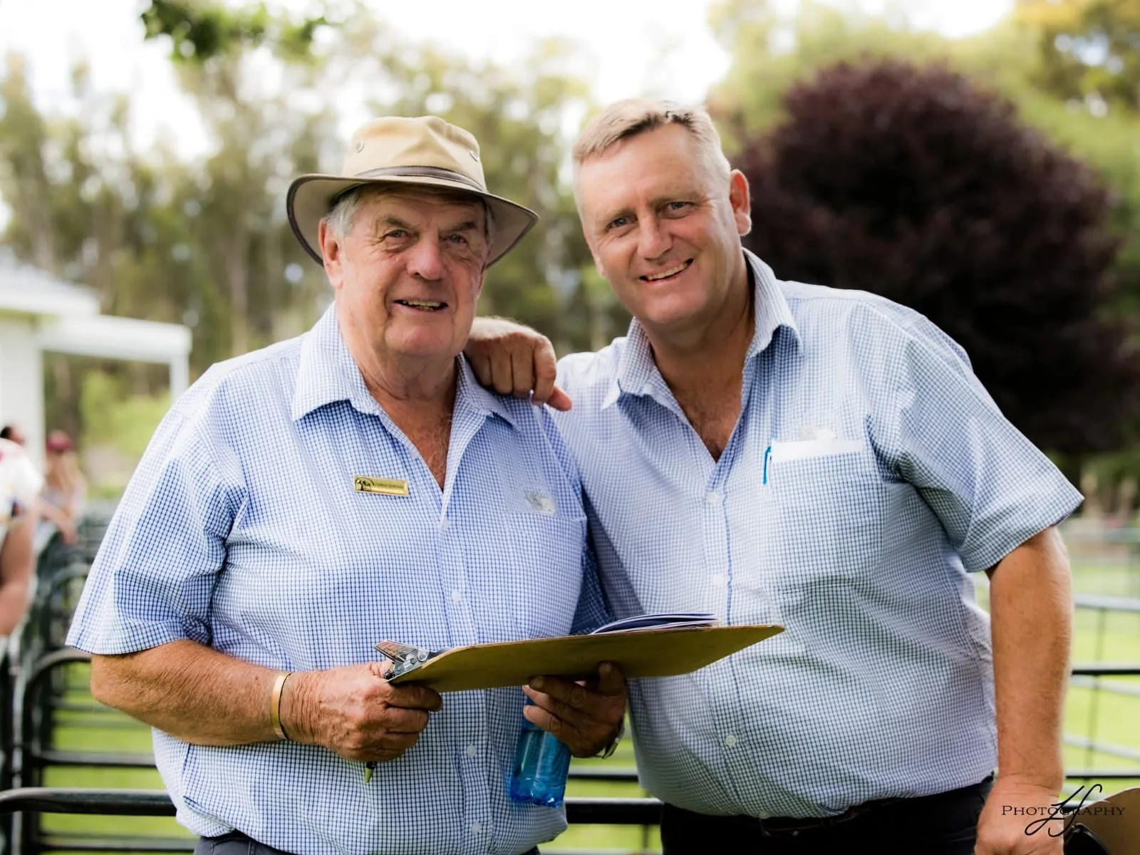 Chris and Ian Sheard consulting at an auction